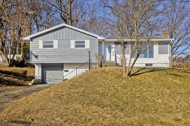 view of front of home featuring a front yard and a garage