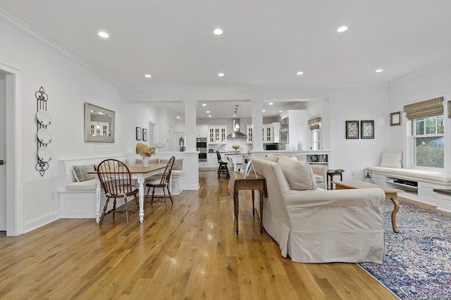 living room featuring light hardwood / wood-style flooring and crown molding