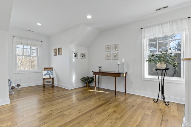 sitting room featuring vaulted ceiling and light hardwood / wood-style flooring