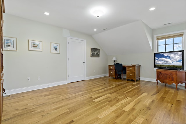 office with lofted ceiling and light hardwood / wood-style floors