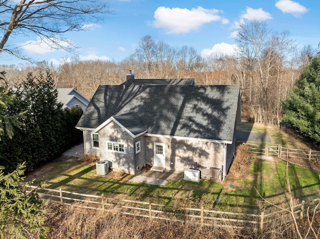 back of house with central AC unit