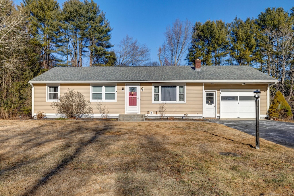 ranch-style house with a front lawn and a garage