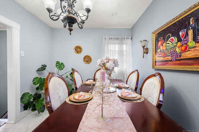 dining space featuring a textured ceiling and a chandelier