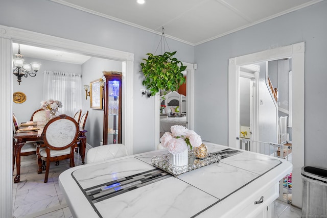 dining area featuring ornamental molding and a chandelier