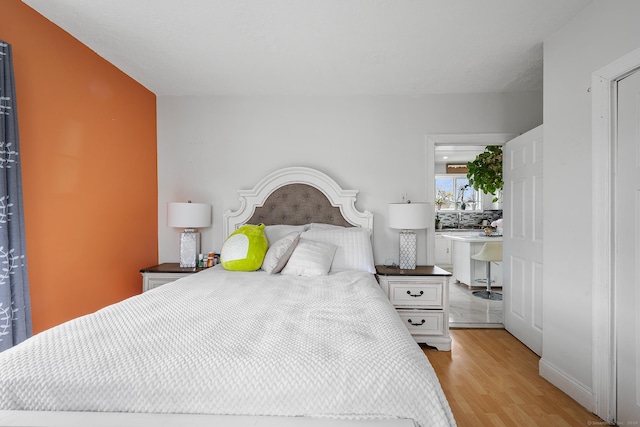 bedroom with light hardwood / wood-style floors