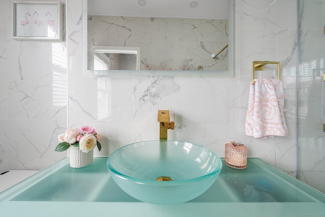 bathroom with sink and tile walls