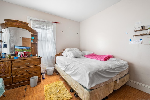 bedroom with light parquet flooring