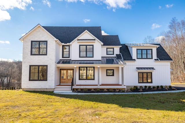 modern farmhouse style home featuring a front lawn and a porch