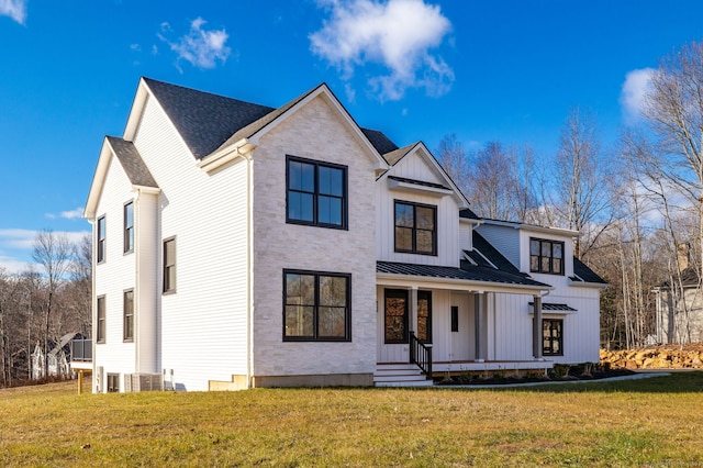 modern farmhouse with covered porch and a front yard