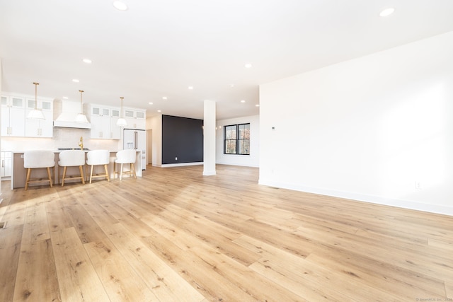 unfurnished living room featuring light hardwood / wood-style flooring