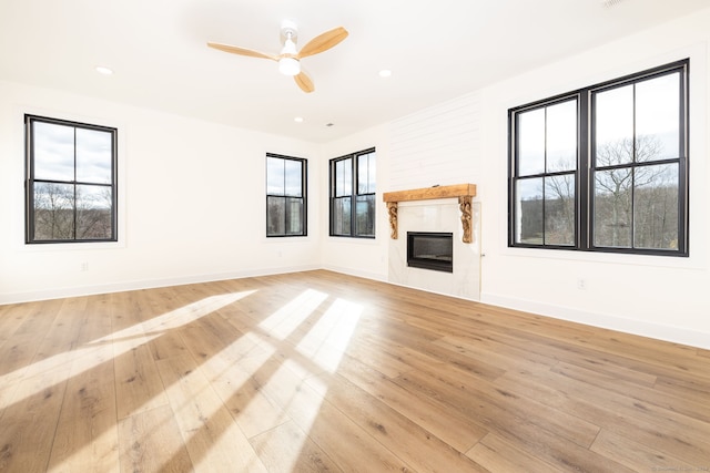 unfurnished living room with ceiling fan and light hardwood / wood-style floors