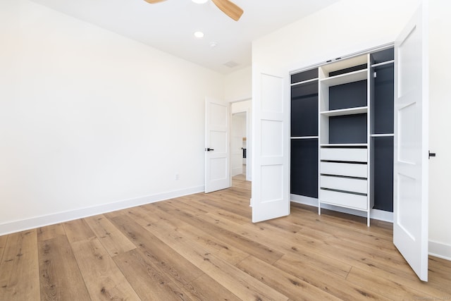 unfurnished bedroom with a closet, light hardwood / wood-style flooring, and ceiling fan