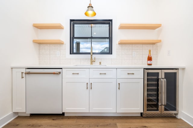 bar with white cabinetry, wine cooler, white dishwasher, and sink