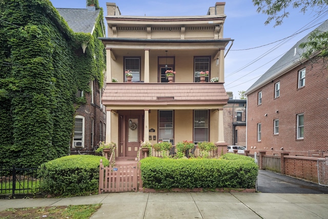 view of front of house featuring a balcony