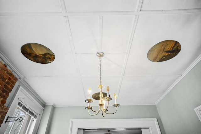 room details with ornamental molding and an inviting chandelier