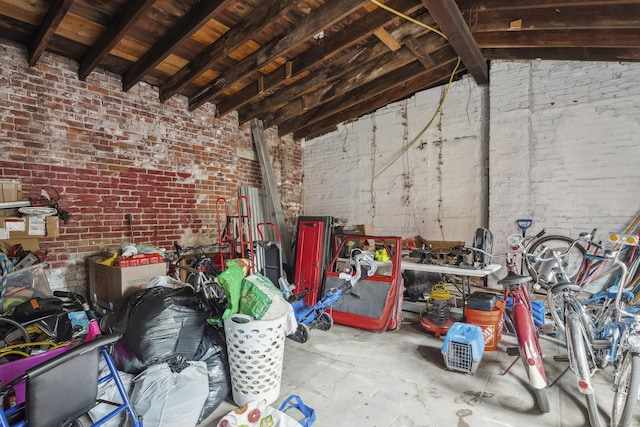 interior space with brick wall and vaulted ceiling