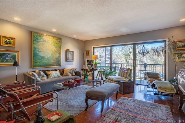 living room featuring dark wood-type flooring and a textured ceiling