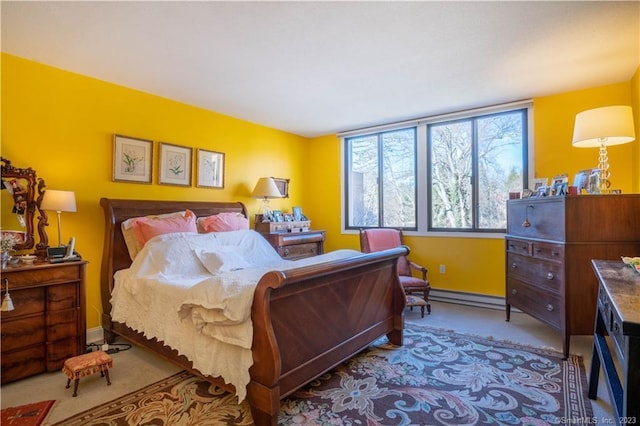 carpeted bedroom featuring a baseboard heating unit