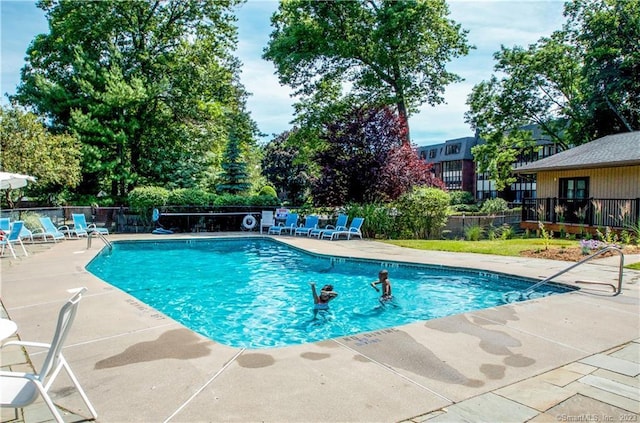 view of swimming pool with a patio