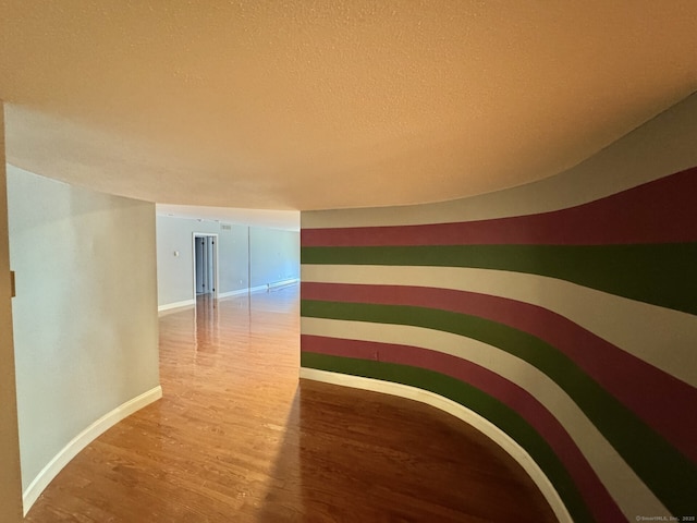 795 Prospect Ave Unit B-5, West Hartford, CT 06105 - detailed view of wood finished floors, a textured ceiling, and baseboards