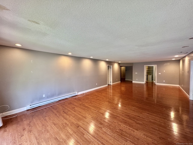 795 Prospect Ave Unit B-5, West Hartford, CT 06105 - spare room with a baseboard radiator, a textured ceiling, wood finished floors, recessed lighting, and baseboards