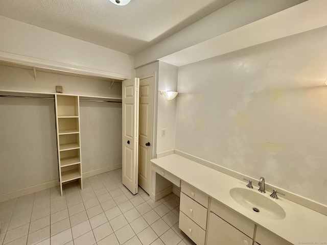 795 Prospect Ave Unit B-5, West Hartford, CT 06105 - bathroom featuring tile patterned floors, vanity, a textured ceiling, and a spacious closet