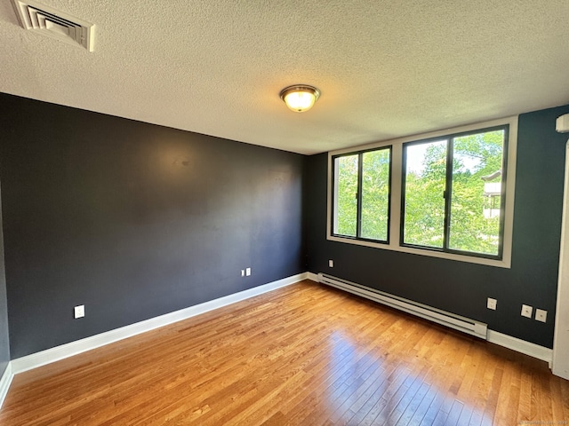 795 Prospect Ave Unit B-5, West Hartford, CT 06105 - unfurnished room with a baseboard radiator, hardwood / wood-style flooring, a textured ceiling, and baseboards