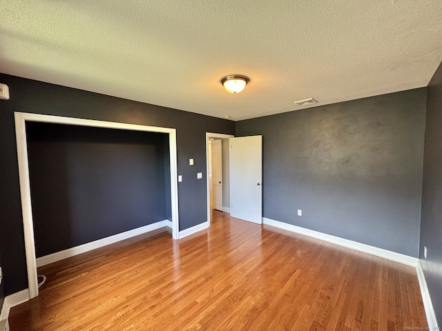 795 Prospect Ave Unit B-5, West Hartford, CT 06105 - unfurnished bedroom featuring wood finished floors, a textured ceiling, and baseboards