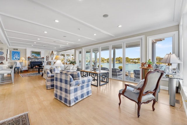 living room featuring beam ceiling, light wood-type flooring, a water view, and crown molding