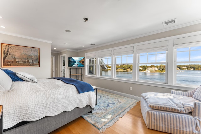 bedroom featuring crown molding and light hardwood / wood-style floors