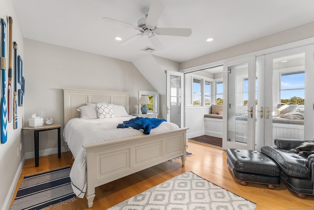 bedroom featuring access to outside, multiple windows, ceiling fan, and light wood-type flooring