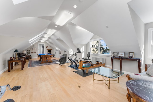 workout area with radiator heating unit, hardwood / wood-style flooring, vaulted ceiling, and billiards