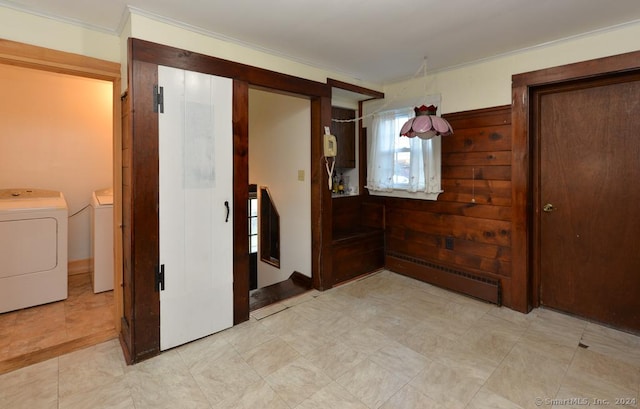 hall featuring baseboard heating, washing machine and dryer, and crown molding