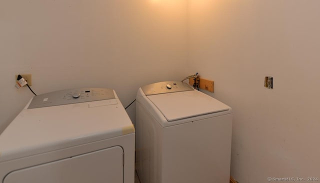 clothes washing area with separate washer and dryer