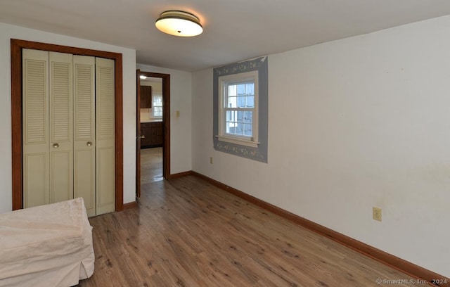 unfurnished bedroom featuring a closet and wood-type flooring