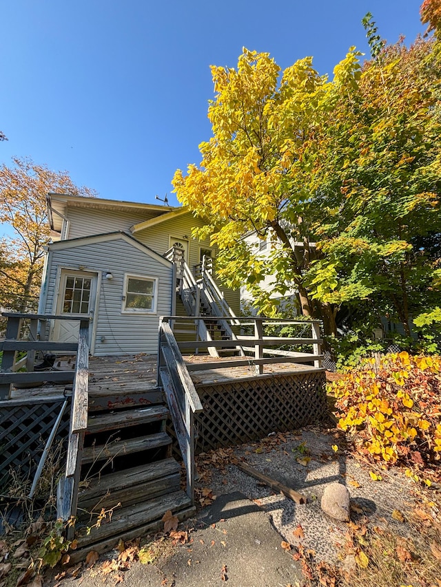 rear view of property featuring a wooden deck