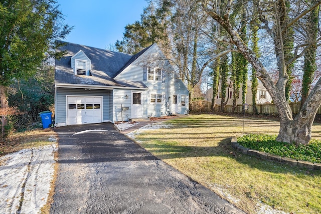 view of front of house with a front yard and a garage