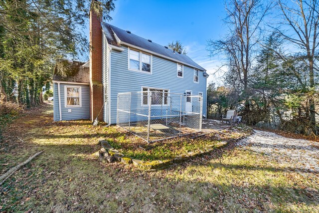 rear view of house with a yard and a patio