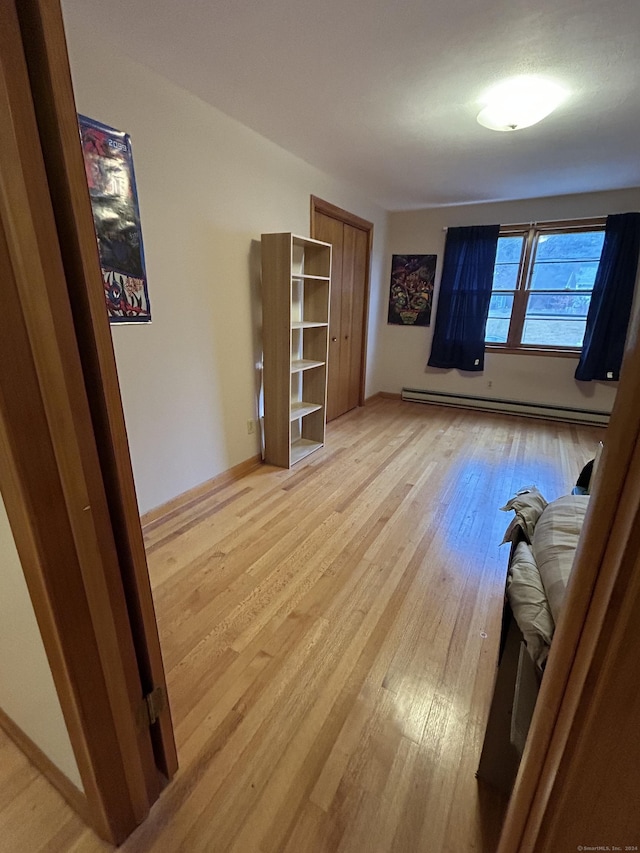 interior space with light hardwood / wood-style floors and a baseboard radiator