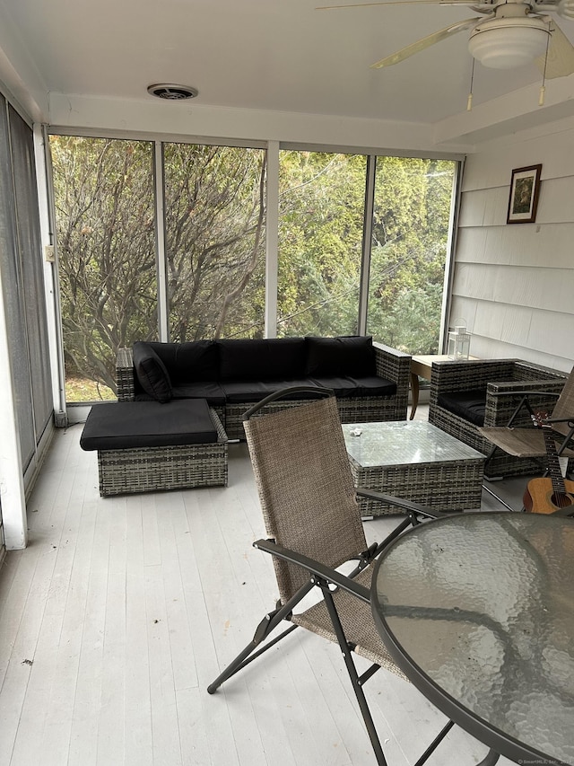 sunroom / solarium with ceiling fan and a wealth of natural light