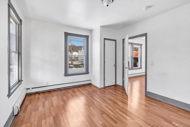 spare room featuring light hardwood / wood-style floors and a baseboard radiator