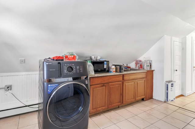 laundry area featuring light tile patterned flooring, washer / dryer, and a baseboard radiator