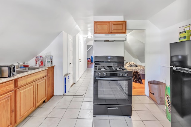 kitchen featuring sink, light tile patterned floors, and black appliances