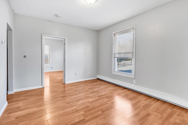 spare room with light hardwood / wood-style flooring and a baseboard radiator