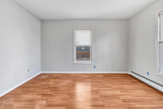 spare room featuring light hardwood / wood-style flooring and a baseboard heating unit