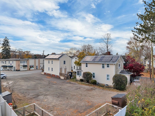 back of property featuring solar panels