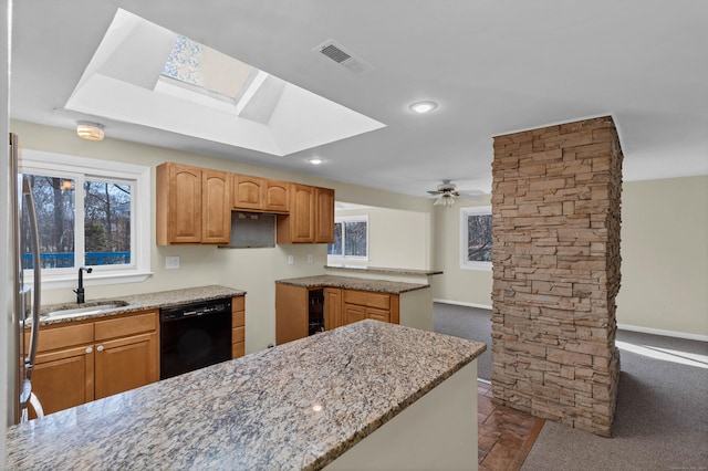 kitchen with dishwasher, ceiling fan, light stone counters, and sink