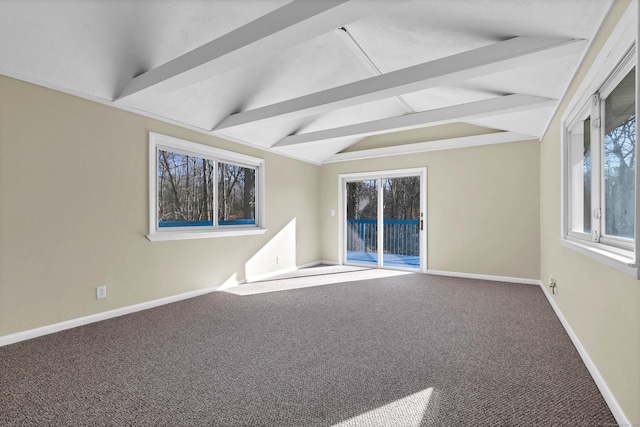 spare room featuring carpet flooring and vaulted ceiling with beams