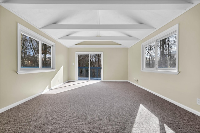 spare room with carpet flooring and vaulted ceiling with beams