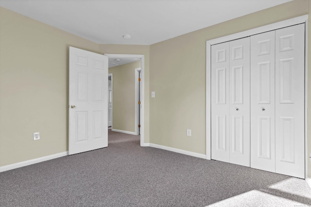 unfurnished bedroom with a closet and carpet floors